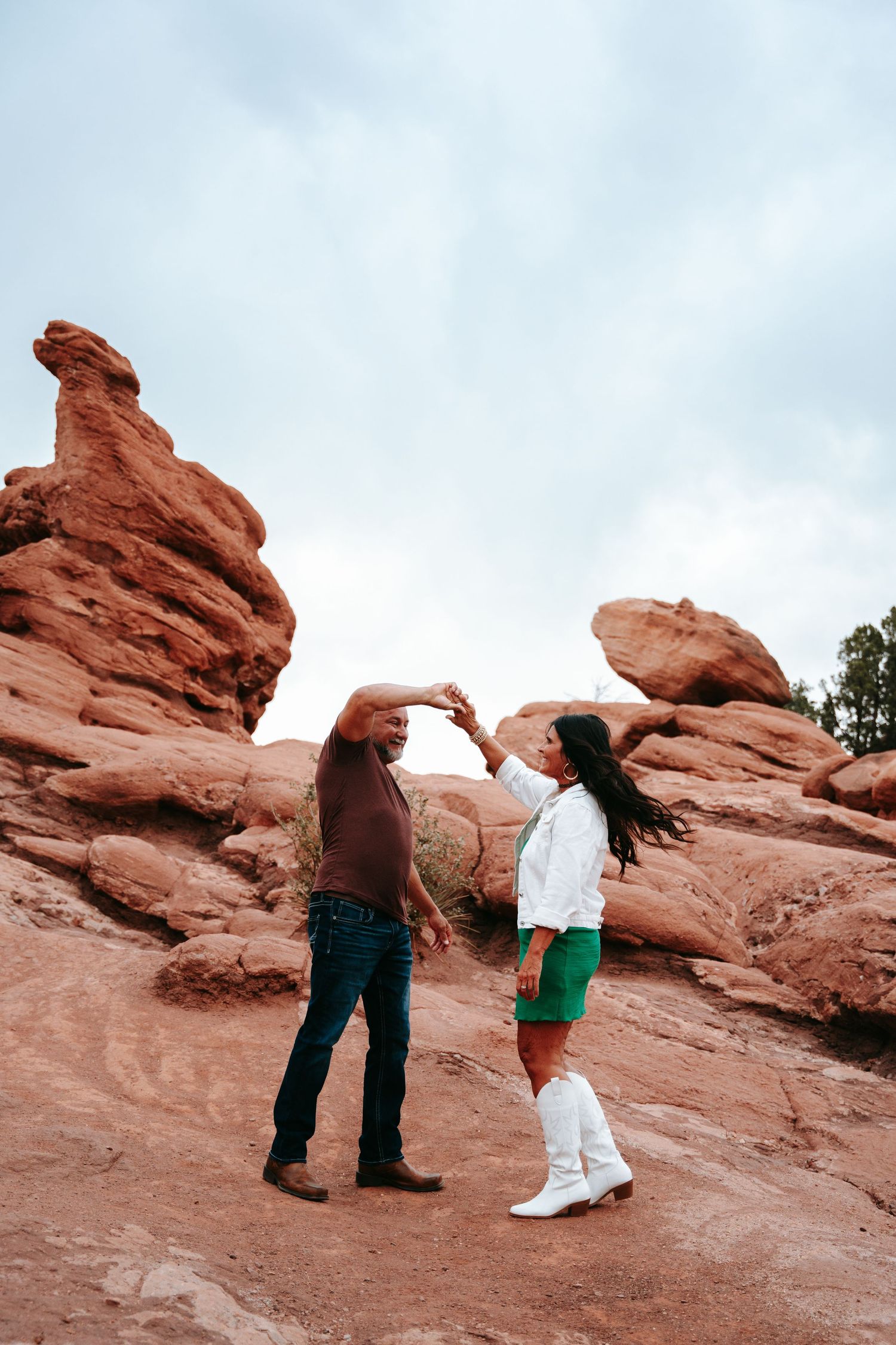 Couple dancing together among red rock formations at Garden of the Gods, Colorado.