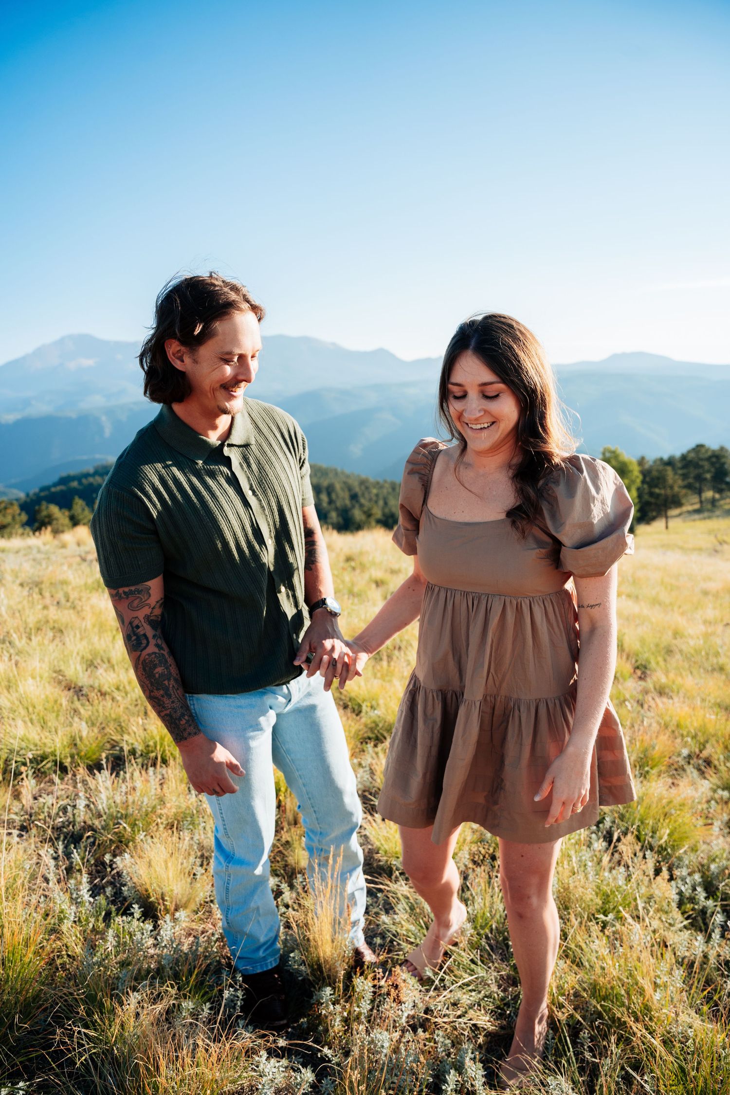 Couple smiling walking in a field
