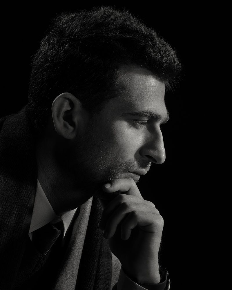 A series of black and white profile portraits showing a contemplative figure in dramatic low-key lighting.