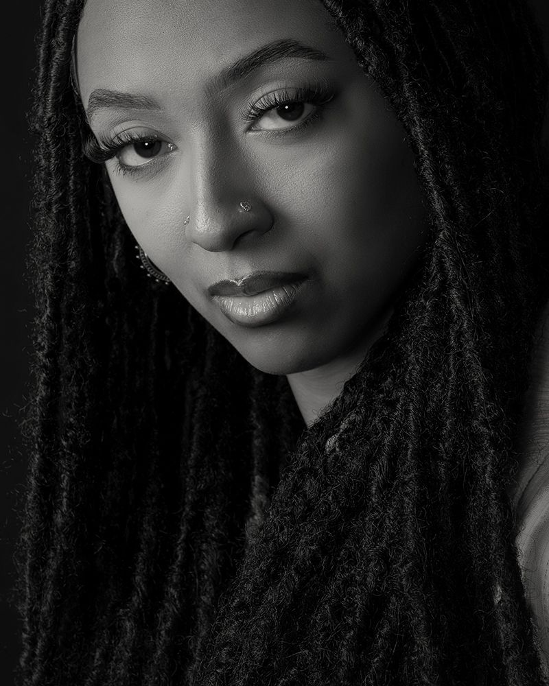 Black and white portraits showing close-up artistic angles of a woman with long locs hairstyle.