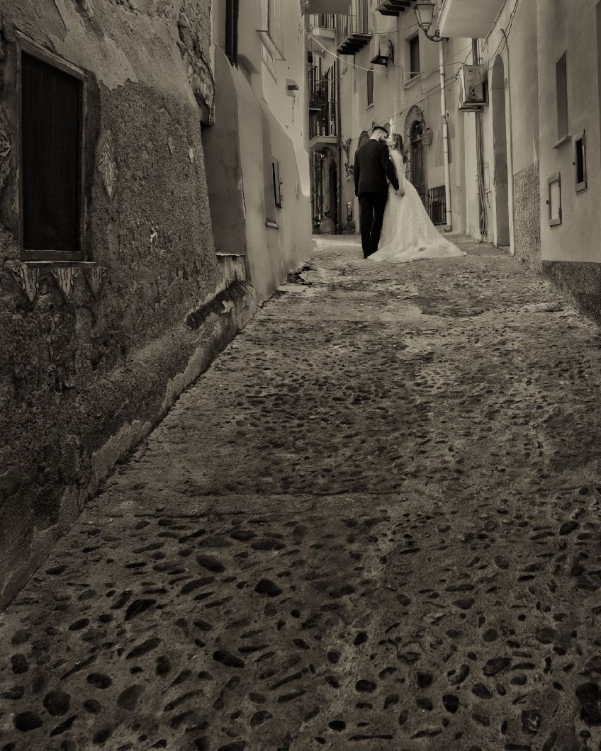 A series of black and white photographs showing narrow cobblestone streets winding through an old Mediterranean village.