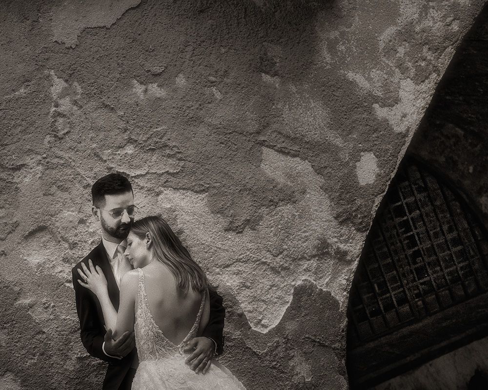 Black and white romantic moment captured against textured stone wall with dramatic lighting.
Horvath-Photography-Sam-Sciarrino