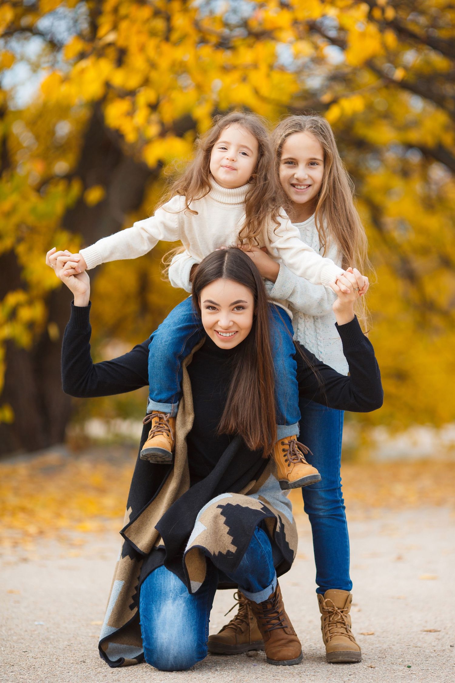 Autumn scene with yellow foliage creating warm backdrop for family moment.