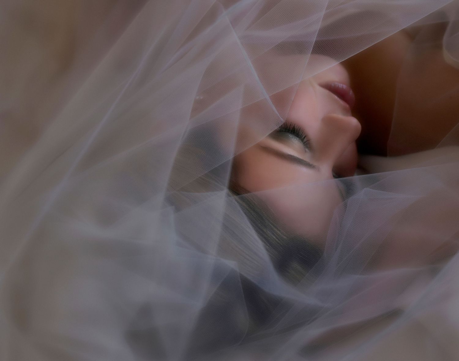 A white wedding veil with delicate lace details flows elegantly in a soft breeze.
Horvath-Photography-Sam-Sciarrino