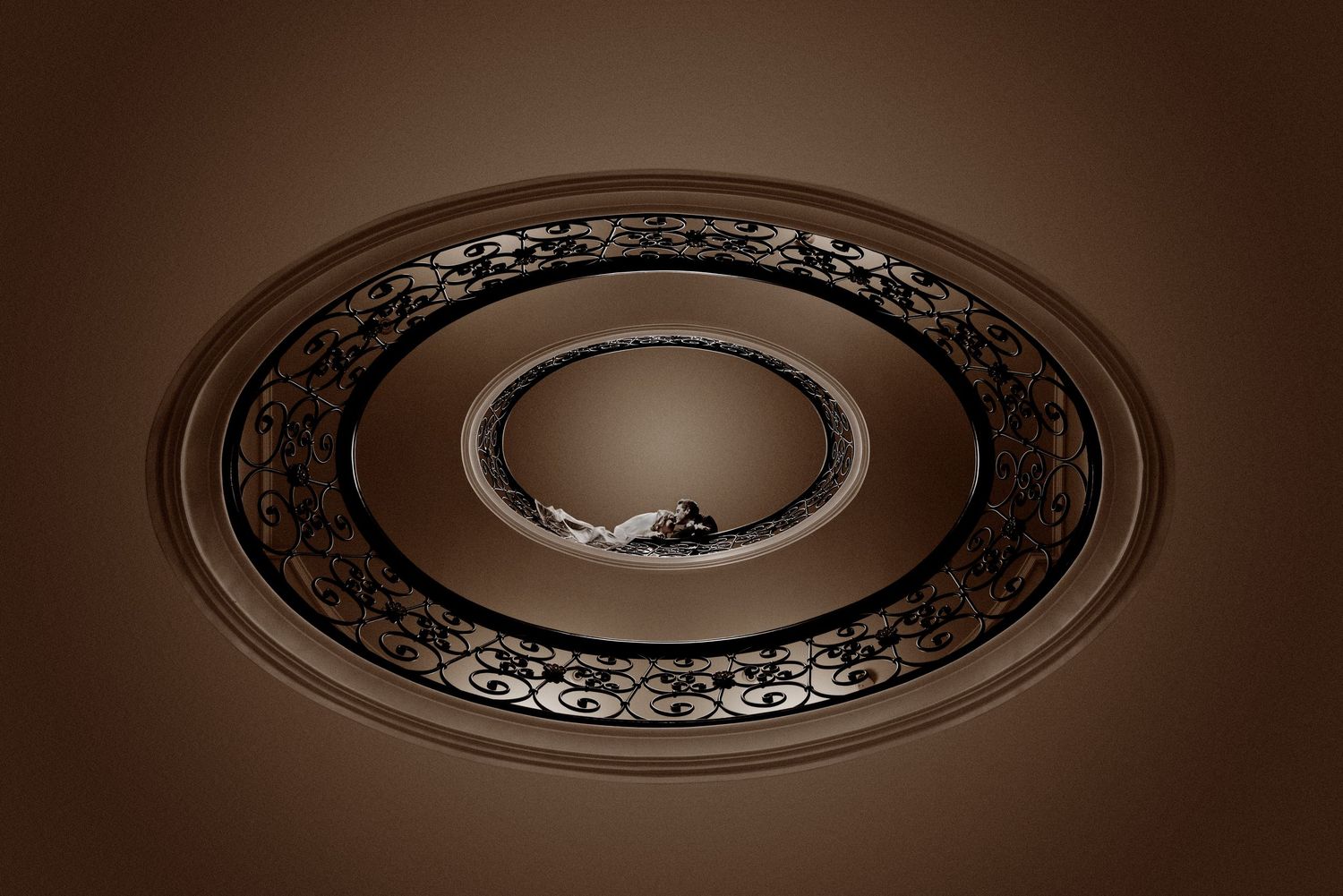 Decorative ceiling medallion with ornate floral pattern shown in sepia tones against dark background.
Horvath-Photography-Sam-Sciarrino