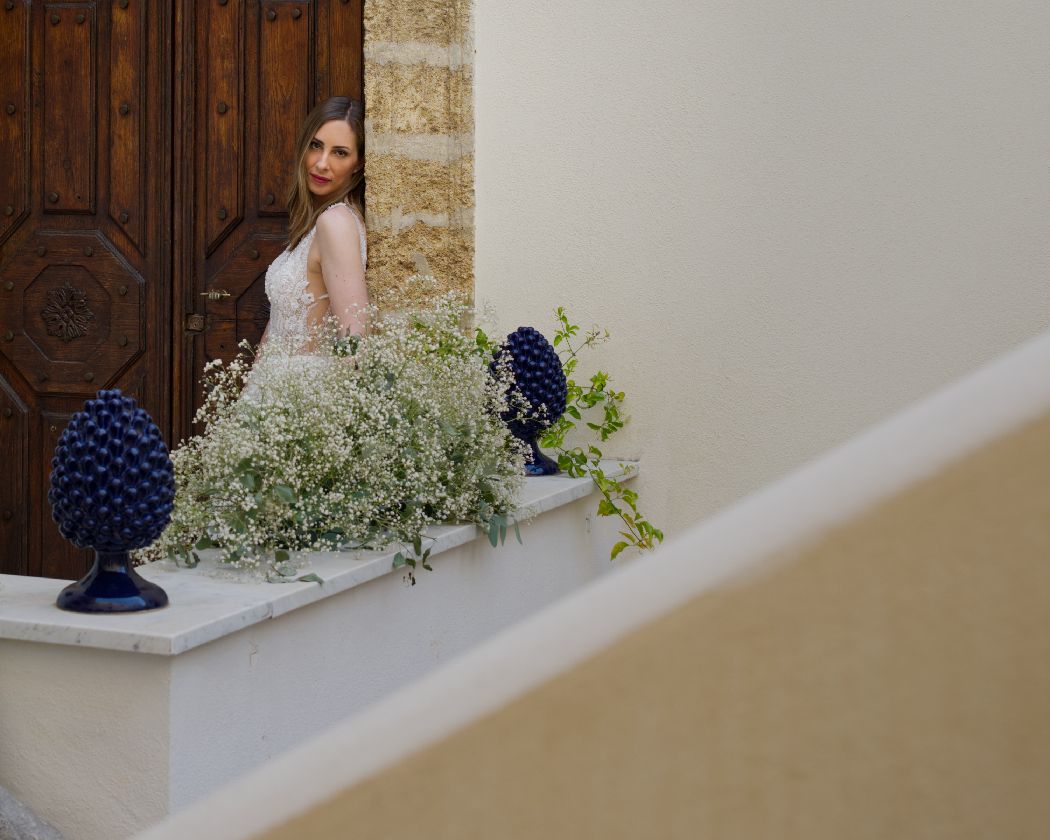 A row of decorative floral arrangements with blue flowers and baby's breath displayed against a light-colored wall.
Horvath-Photography
