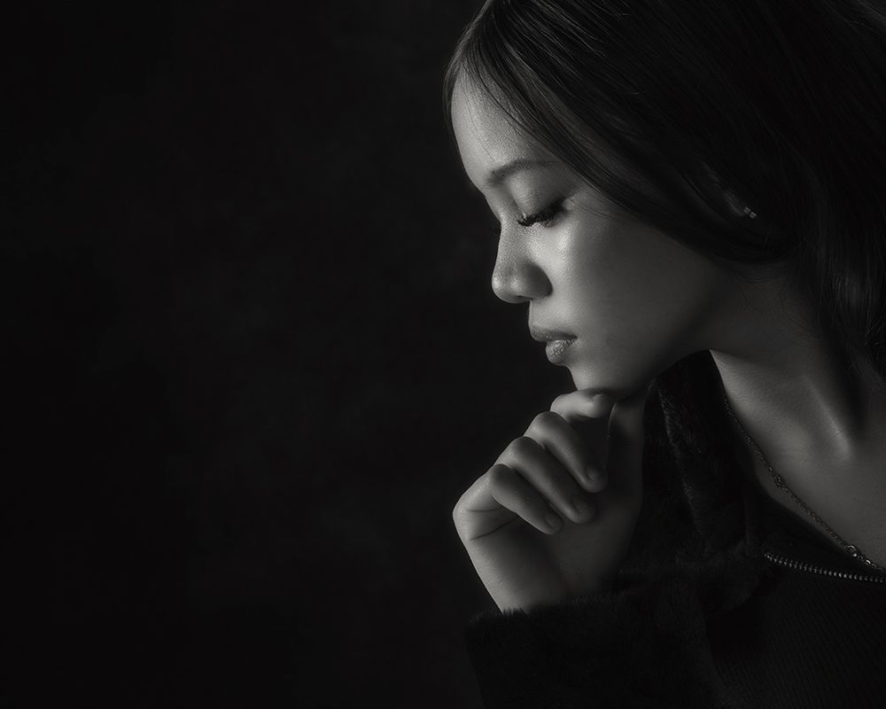 A series of black and white profile portraits showing dramatic lighting and shadows on the subject's face.
