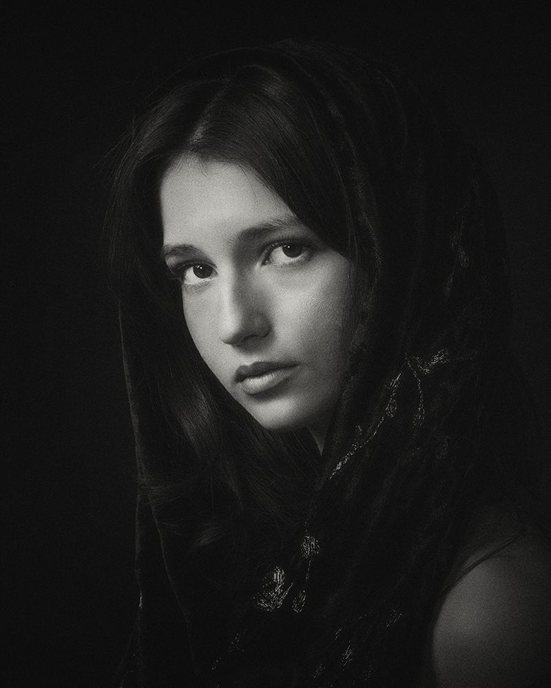 Moody black and white portrait series with dramatic side lighting.