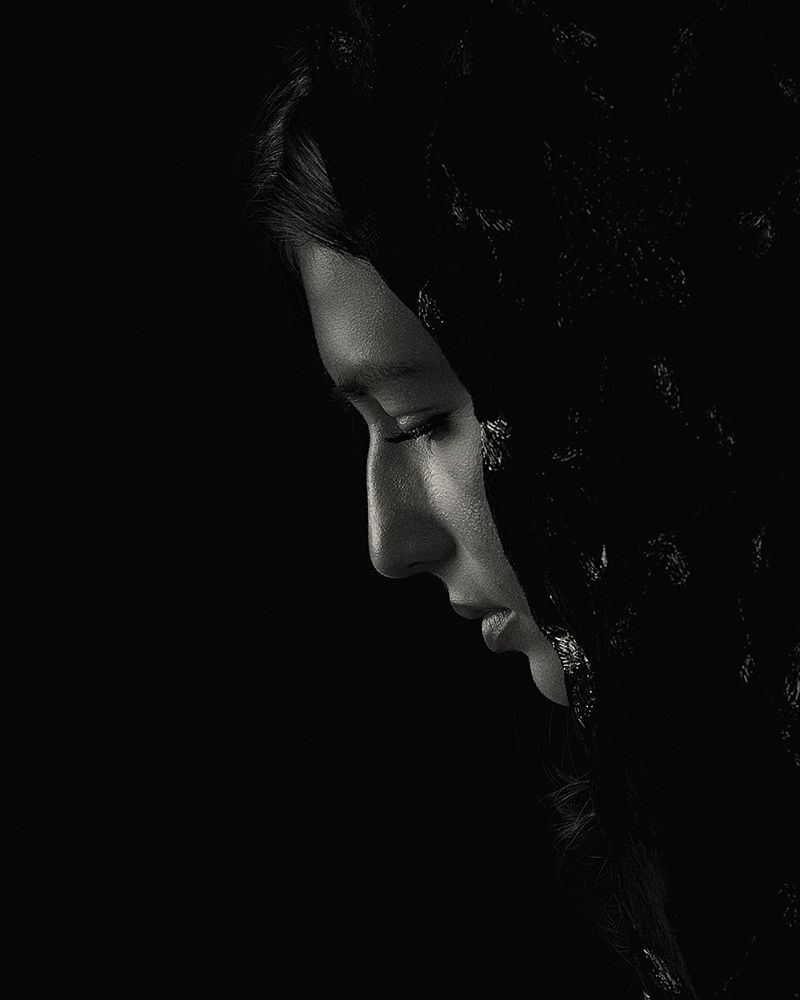 Artistic black and white profile portraits showing dramatic shadows and contrast.