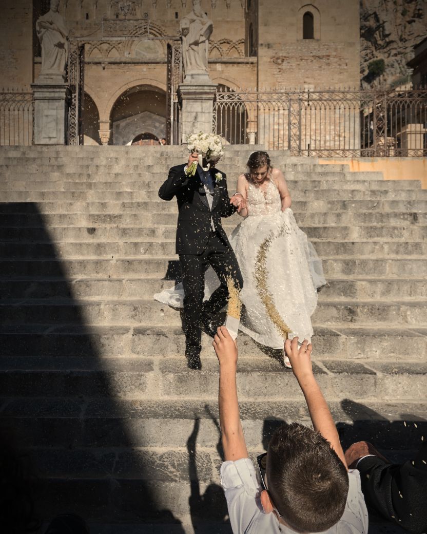 A series of wedding photos showing a couple descending stone steps in dramatic lighting and shadows.
