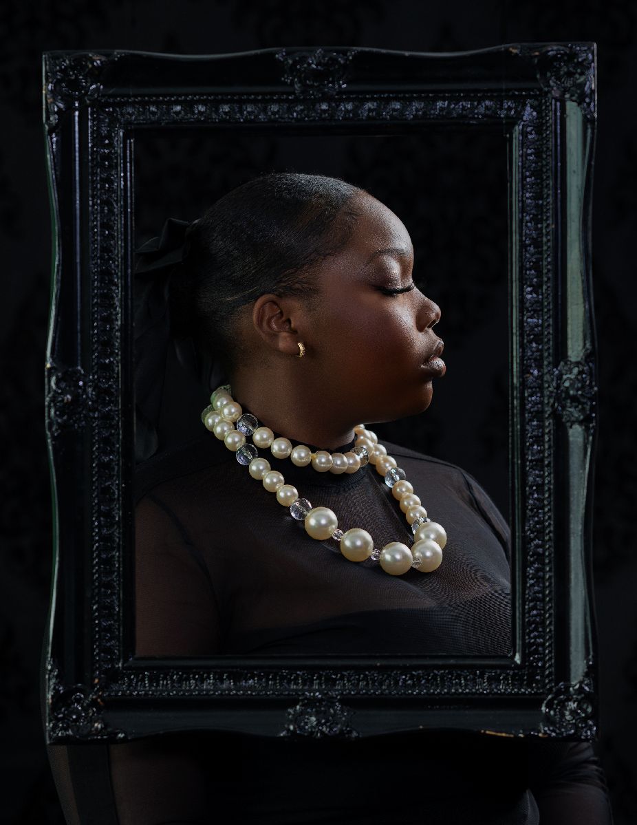 Artistic portrait series showing a pearl necklace against dark skin in dramatic black and white lighting.