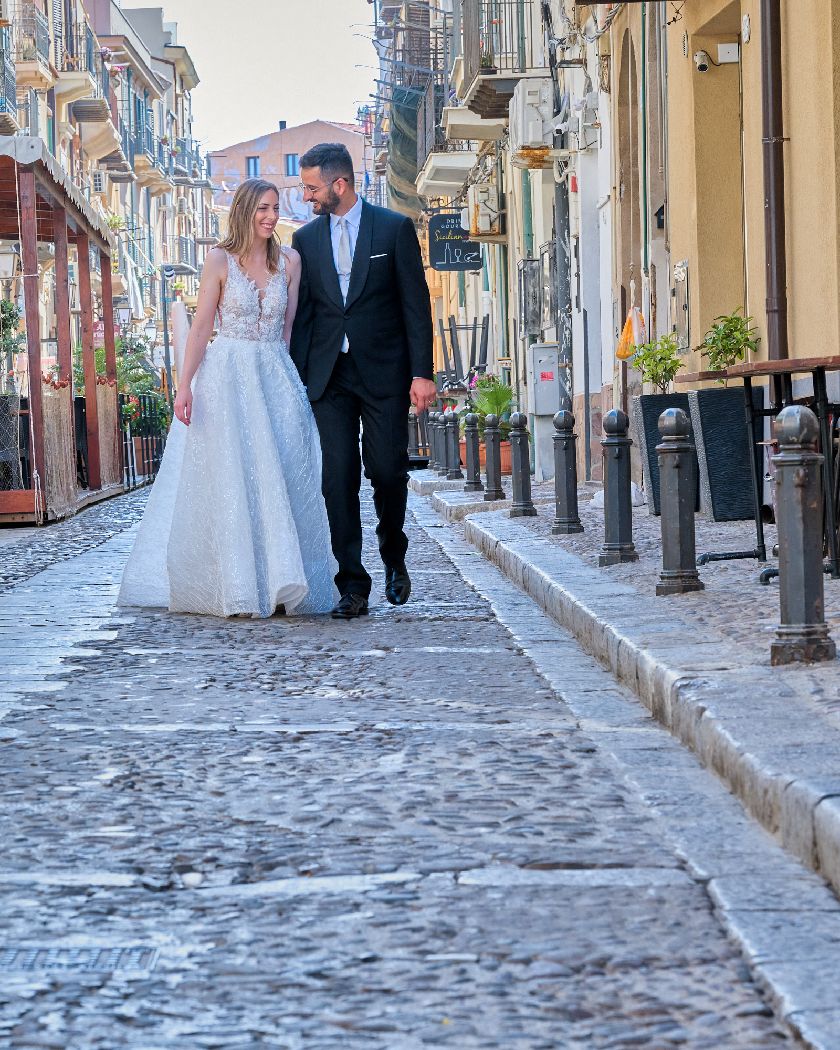 A couple walking along a charming cobblestone street lined with historic European buildings.
Horvath-Photography-Sam-Sciarrino