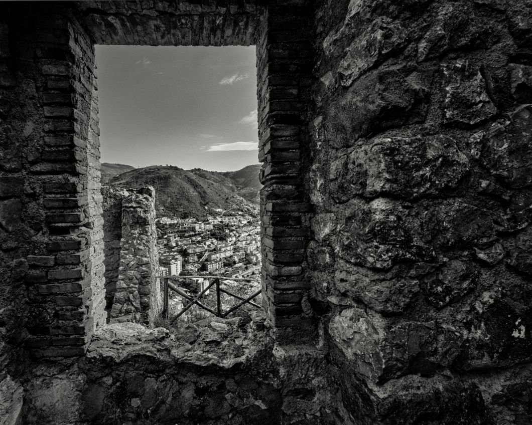 Ancient stone ruins frame a dramatic mountain vista through multiple arched windows in black and white.
Horvath-Photography-Sam-Sciarrino