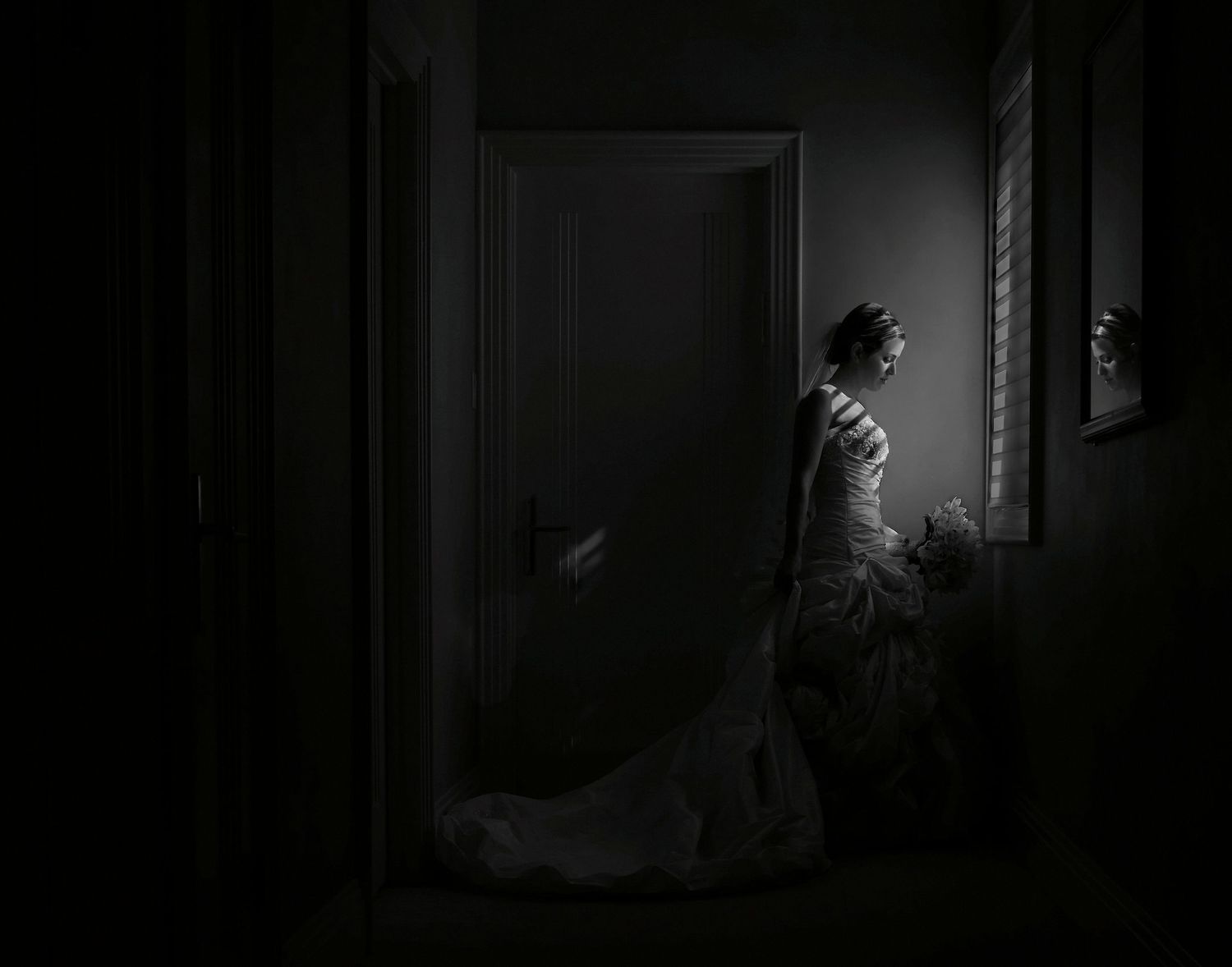 A dark and moody black and white film noir scene shows a figure silhouetted in a doorway with dramatic lighting.
Horvath-Photography