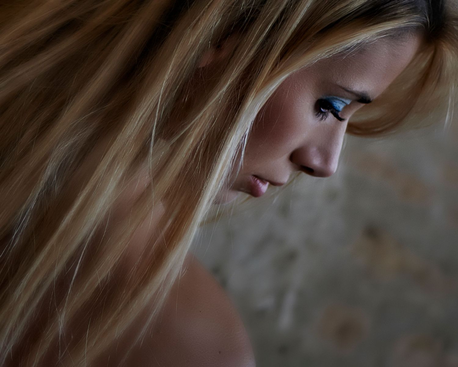 A person with long blonde hair looks down thoughtfully in a series of moody, atmospheric portrait shots.
Horvath-Photography-Sam-Sciarrino
