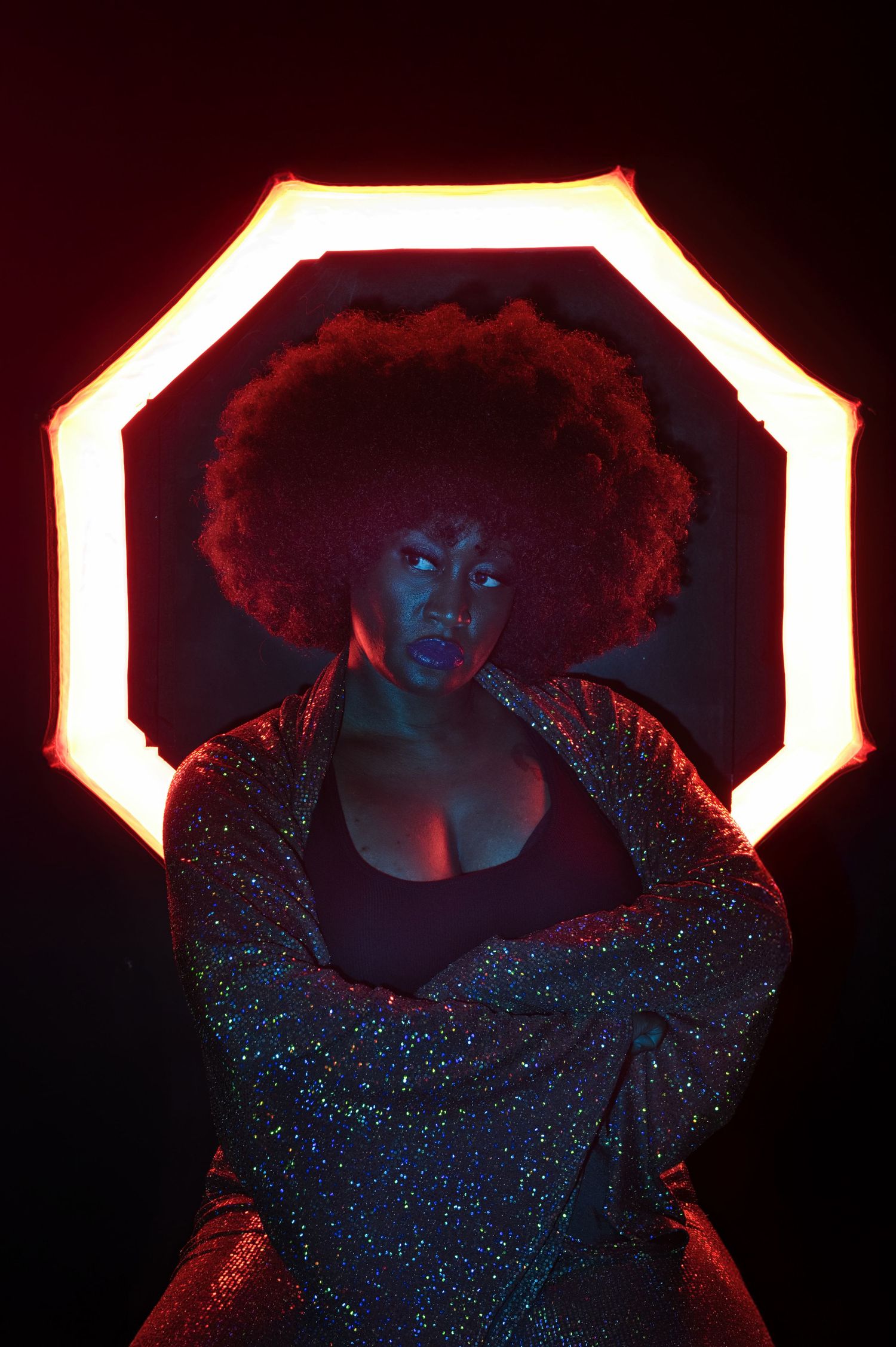 Bold creative portrait with afro silhouette and red backlighting by Atlanta editorial photographer APQ Creative.