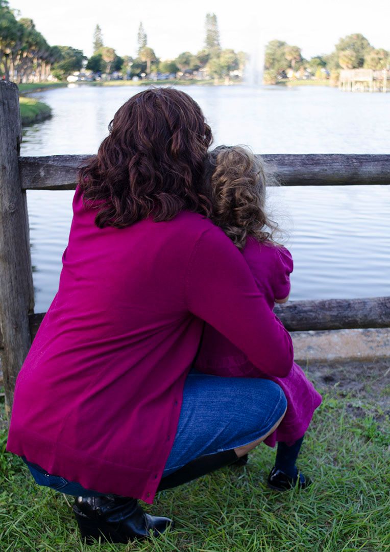 Mother and daughter looking out at water during family photography session in Brevard County, Florida
