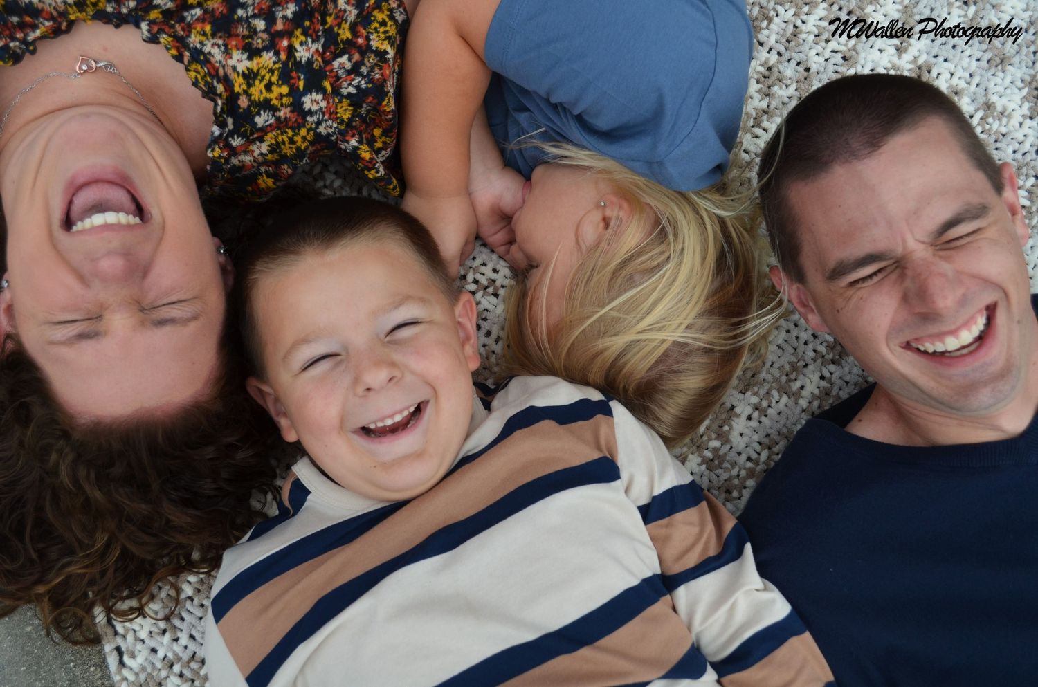 Family laughing together during candid outdoor portrait session in Brevard County, Florida