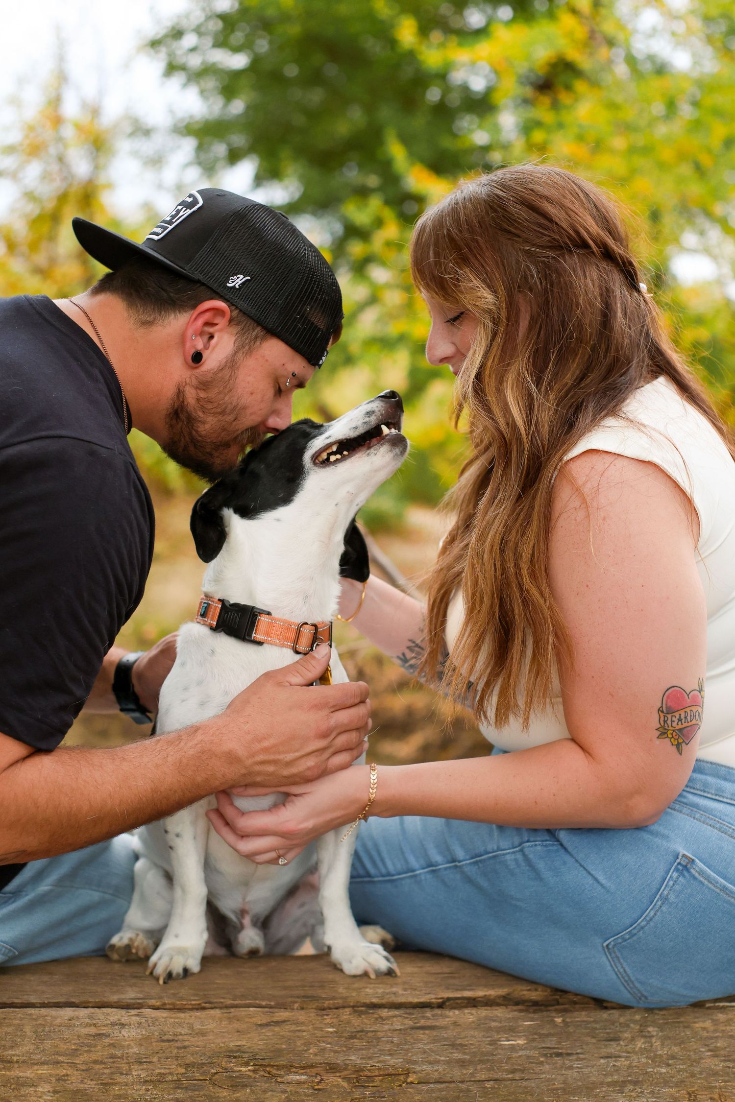 A series of photos showing a couple and their dog sharing sweet kisses and tender moments on a wooden deck.