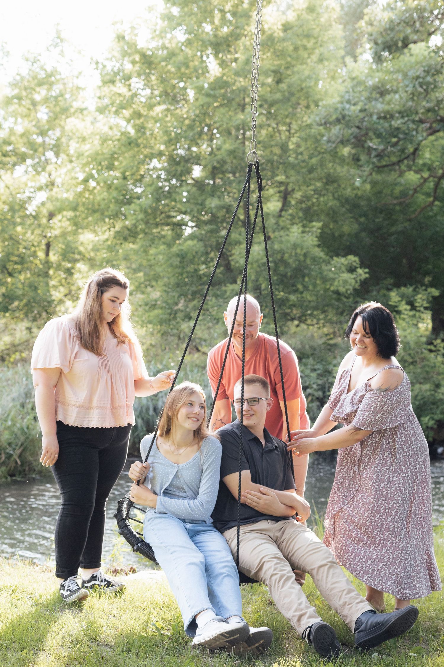 Friends relaxing together on swings in a peaceful outdoor setting.