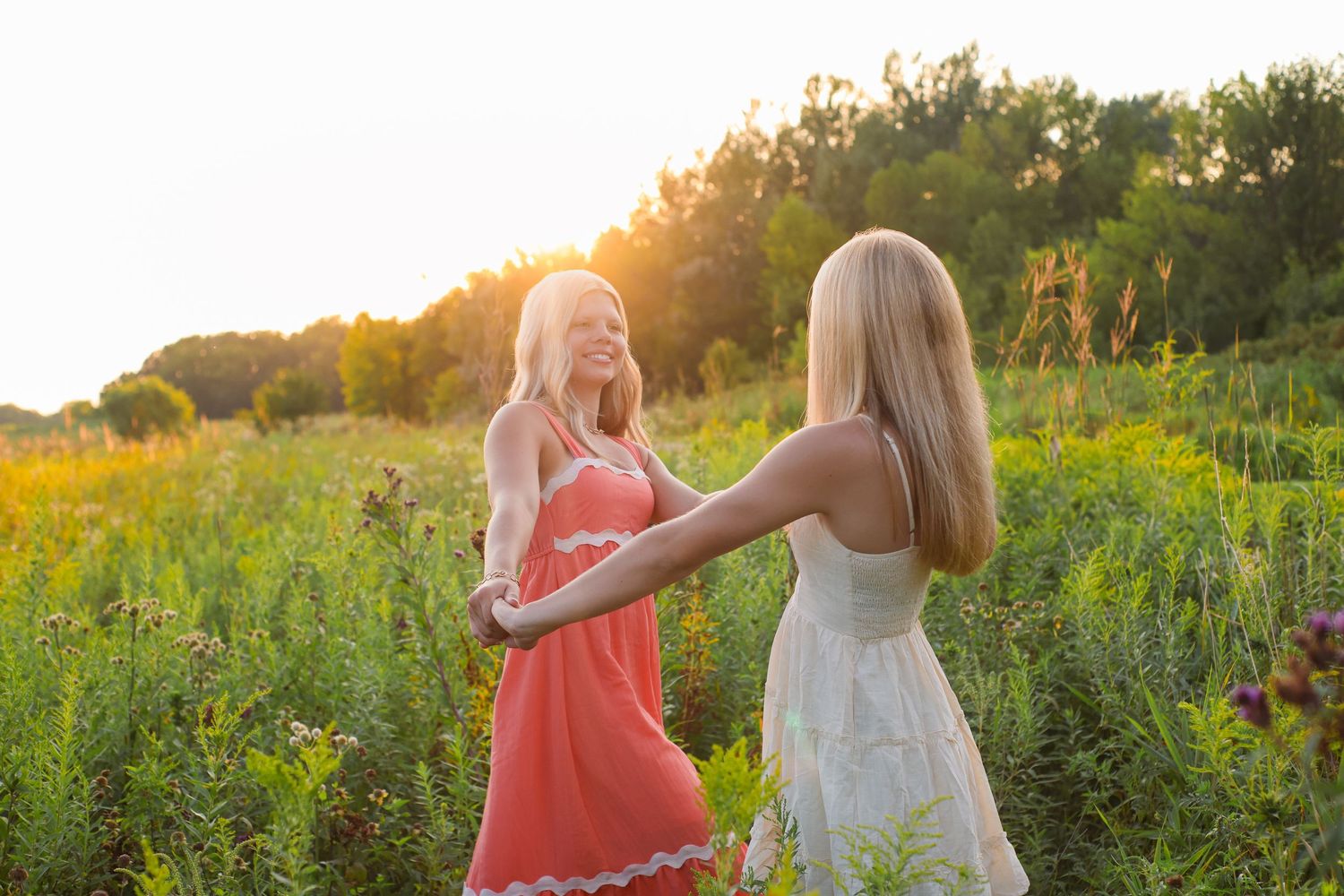 Friends enjoying sunset together in a wildflower meadow.