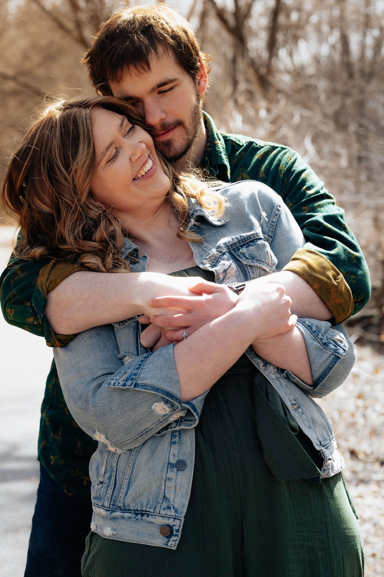 Couple sharing intimate embrace against winter landscape backdrop.