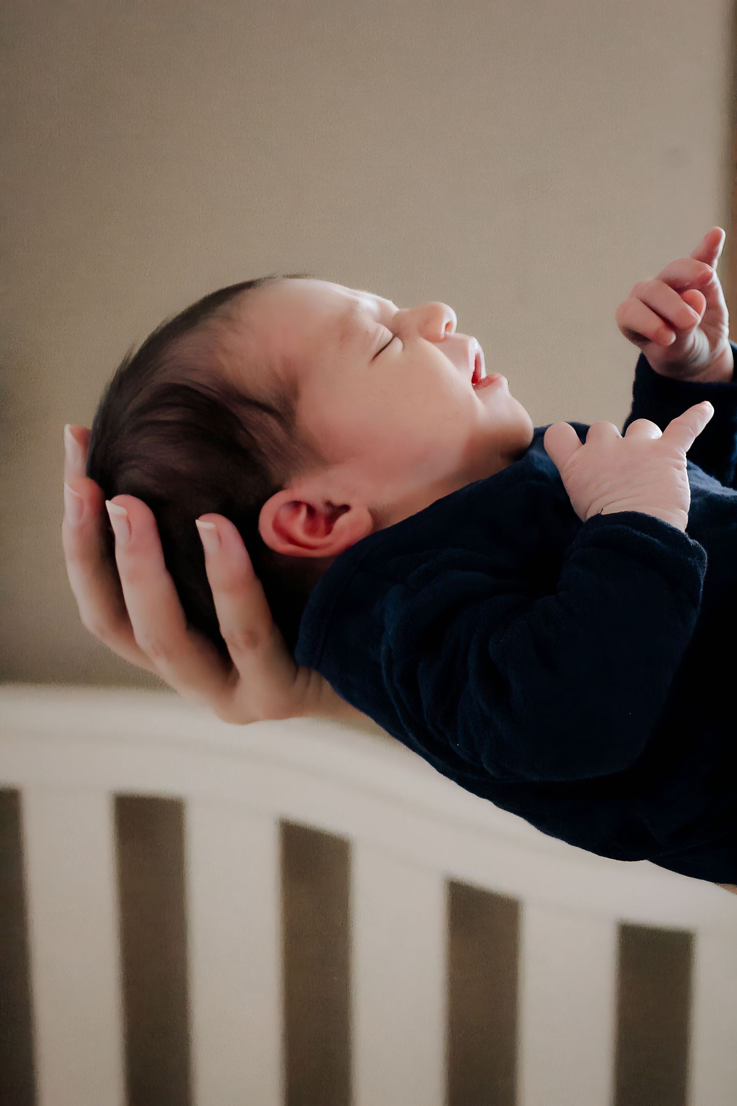 Sequential photos of baby stretching and arching back while lying on a bed.