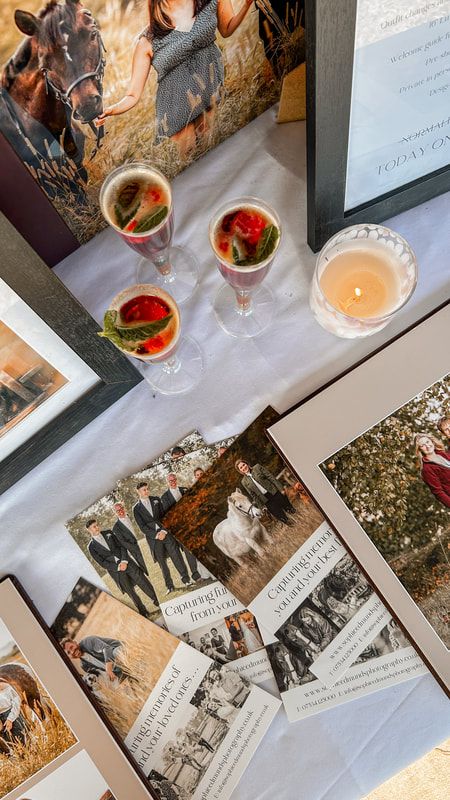 Vintage black and white photographs laid out on a white surface with cocktail glasses and watermelon garnishes.