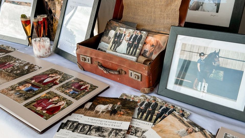 A collection of vintage suitcases and travel trunks stacked together with antique photographs and memorabilia.