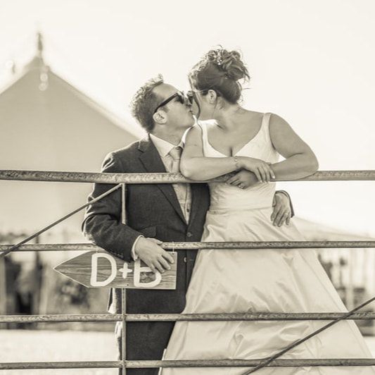 A romantic black and white photo sequence showing a couple sharing tender moments while leaning on a railing.