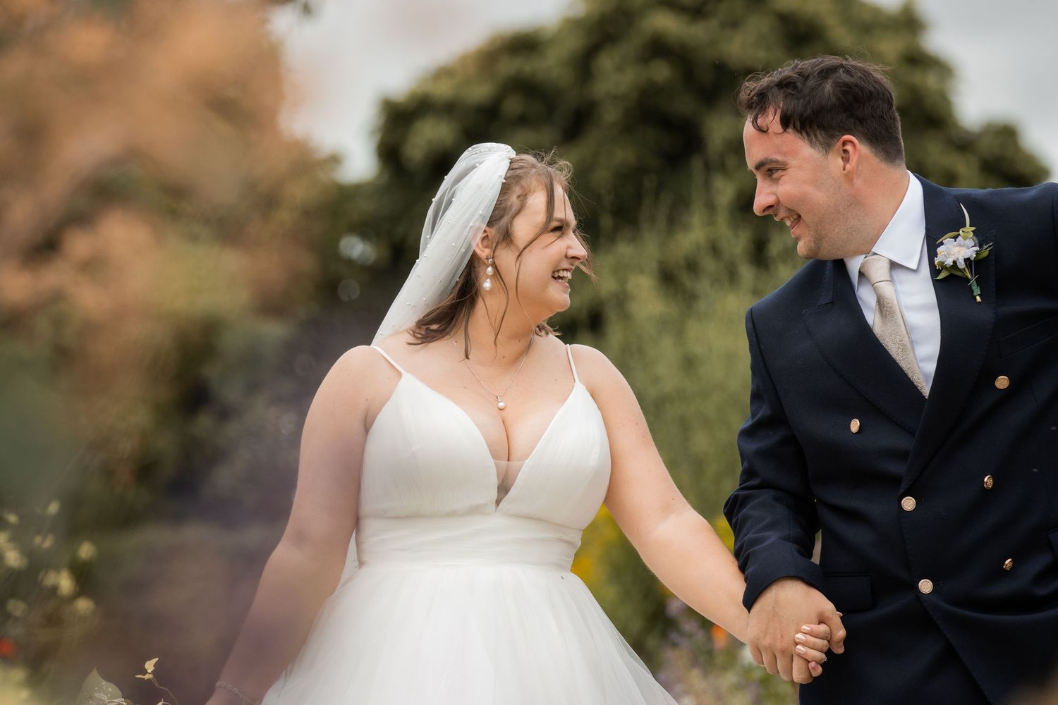 Romantic wedding couple portraits in formal attire against natural backdrop.