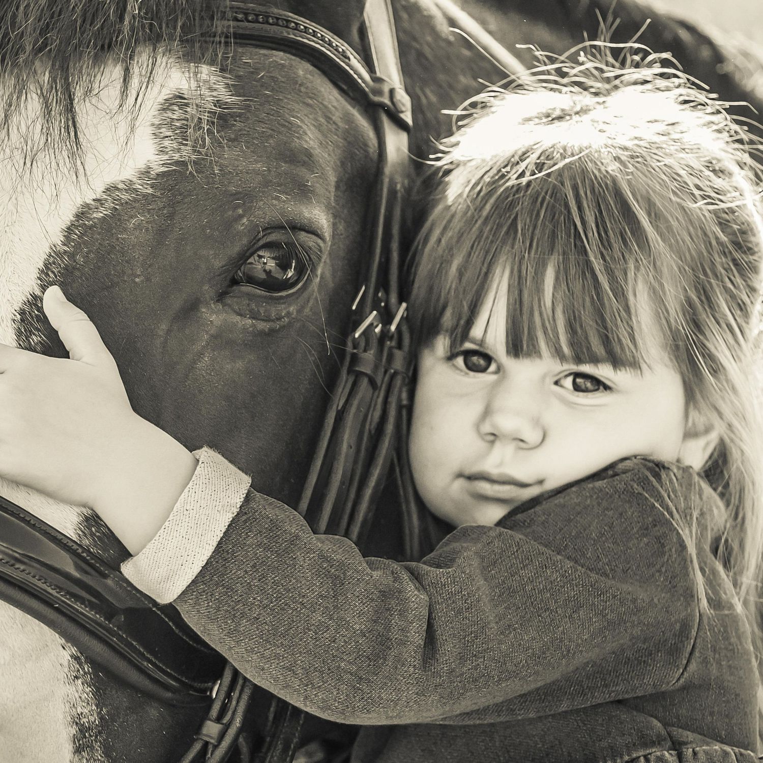 Vintage-style black and white portrait showing gentle interaction between two people.