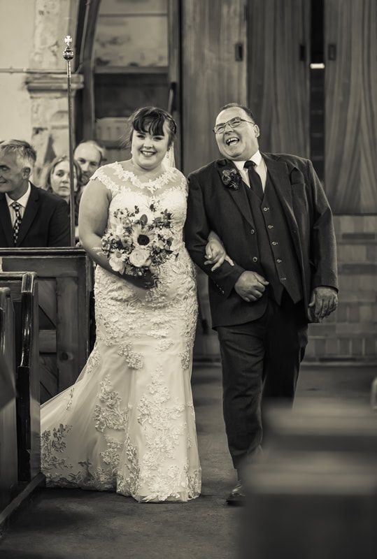 A black and white wedding photo sequence showing a couple walking together in formal attire along a corridor.