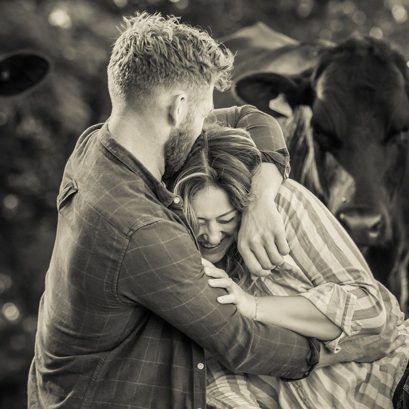 Black and white romantic couple portrait series showing tender embrace and emotional connection in outdoor setting.