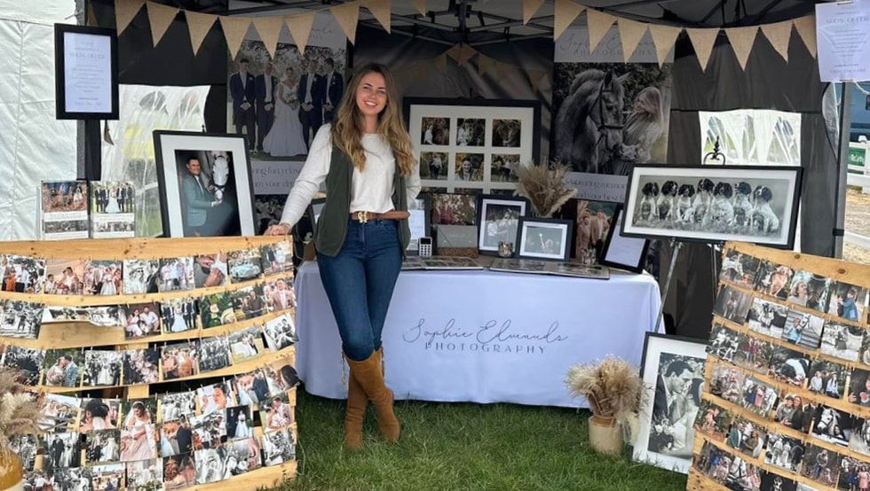 A collage of black and white photo displays mounted on walls with decorative bunting banners hanging above.