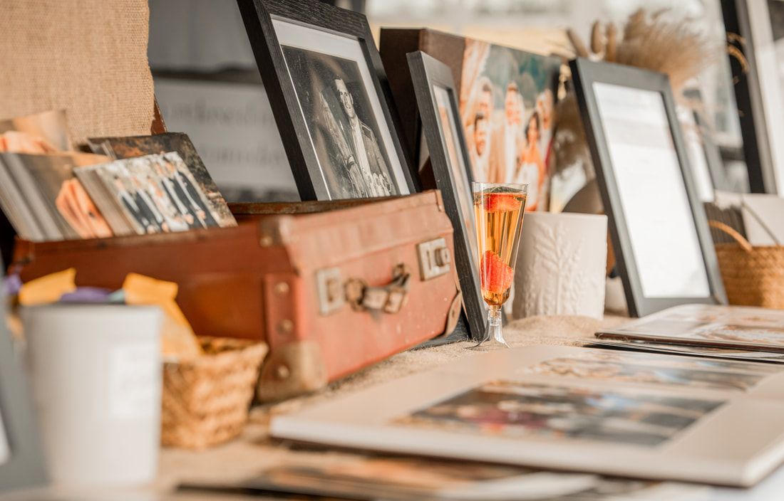 Vintage wooden boxes and picture frames displayed on a shelf with a soft warm filter effect.