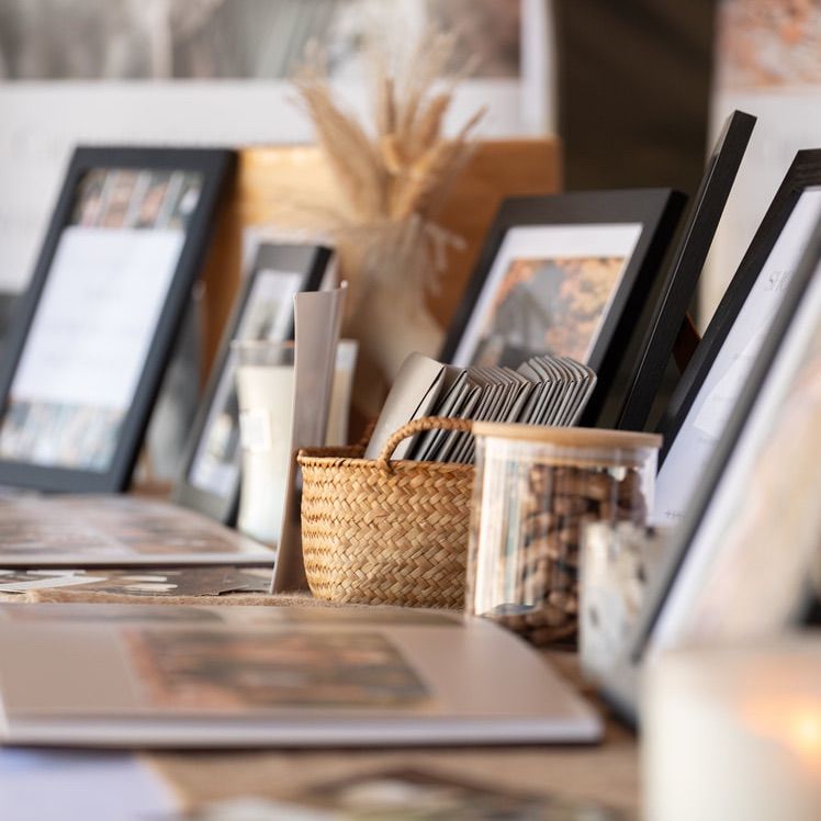 Shallow depth of field view of a modern workspace with blurred office supplies and decor on wooden desk.