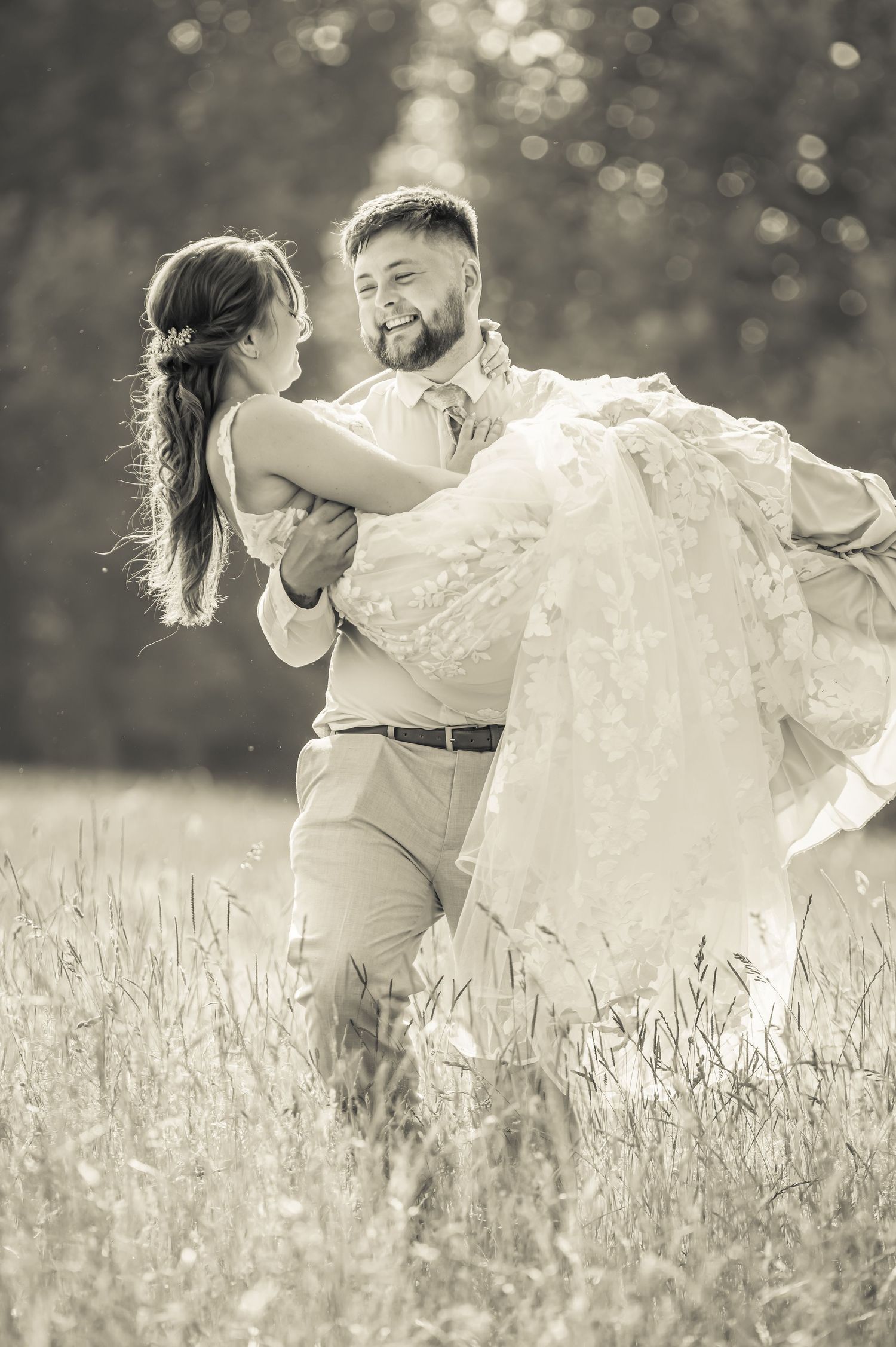 Romantic sequence showing couple spinning and embracing in a sun-drenched meadow.