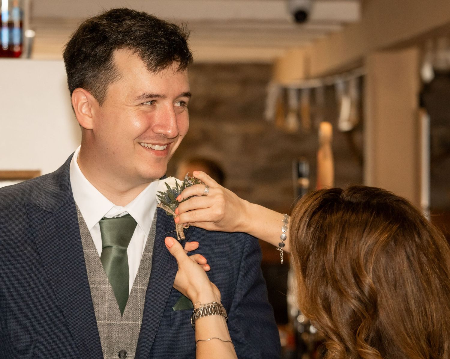 A couple in wedding attire shares a joyful moment during their reception celebration.