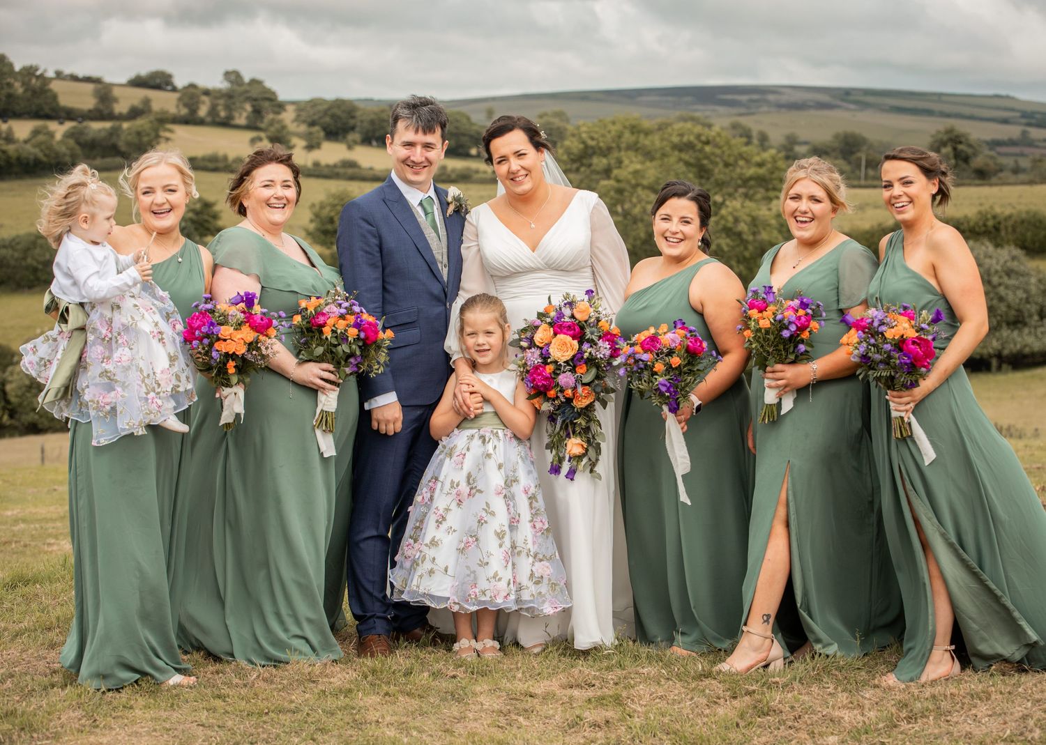 A panoramic collage of wedding party photos featuring bridesmaids in sage green dresses and colorful floral bouquets.