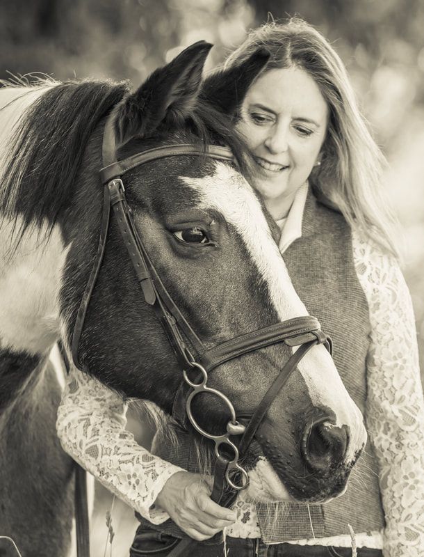 Black and white photo series showing tender moments between a person in lace and their horse in an intimate portrait session.