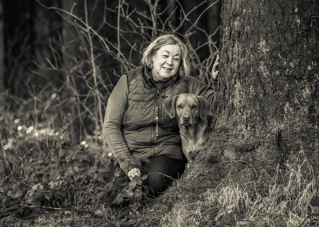 A person and their dog relax together outdoors in a series of black and white photographs showing their close bond.