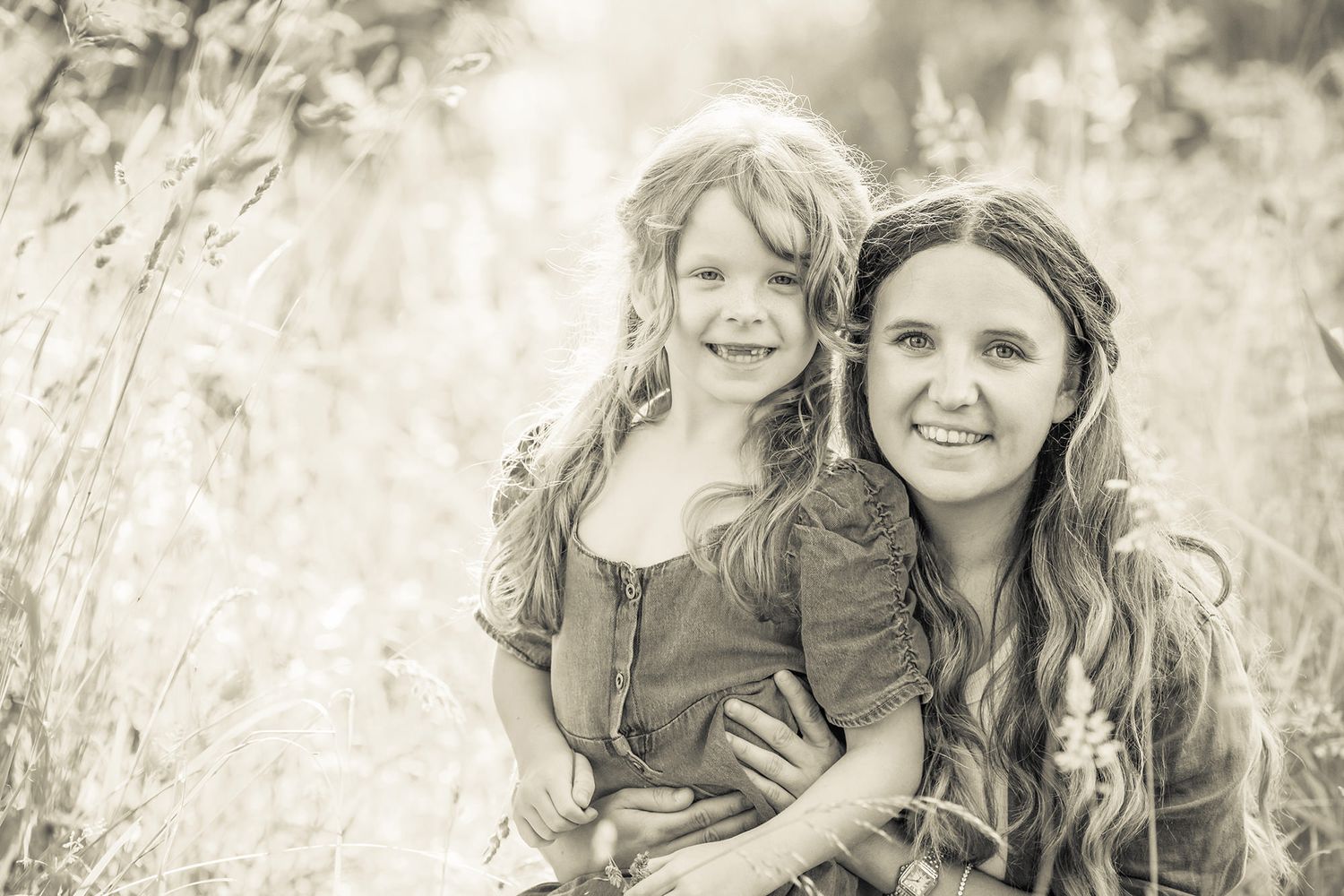 Black and white mother and daughter portrait showing joyful moments together in a natural outdoor setting at their farm in Edington.