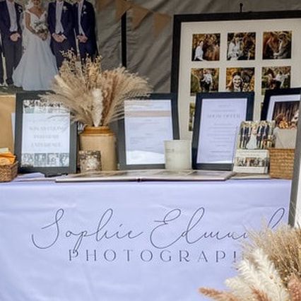 Photography business display with elegant text signage and dried pampas grass decorations.