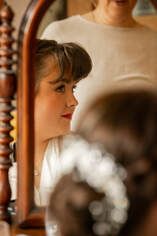 A series of blurred candid portraits showing different facial expressions and emotions in warm lighting.
