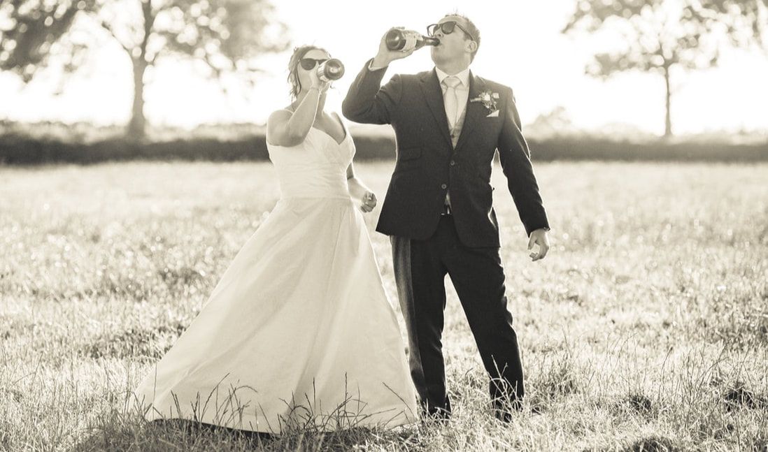 A black and white wedding photo collage showing romantic moments of a couple in formal attire outdoors.