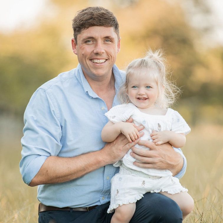A series of outdoor family portraits showing joyful moments between a parent and child in a sunlit field.