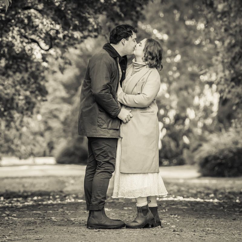 A romantic black and white photo series showing tender moments between a couple in a park setting.
