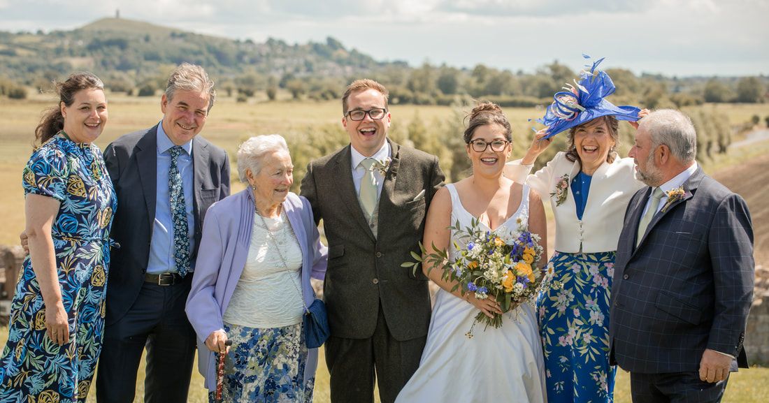 A panoramic collage of outdoor wedding photos showing guests and a couple celebrating in a rustic countryside setting.
