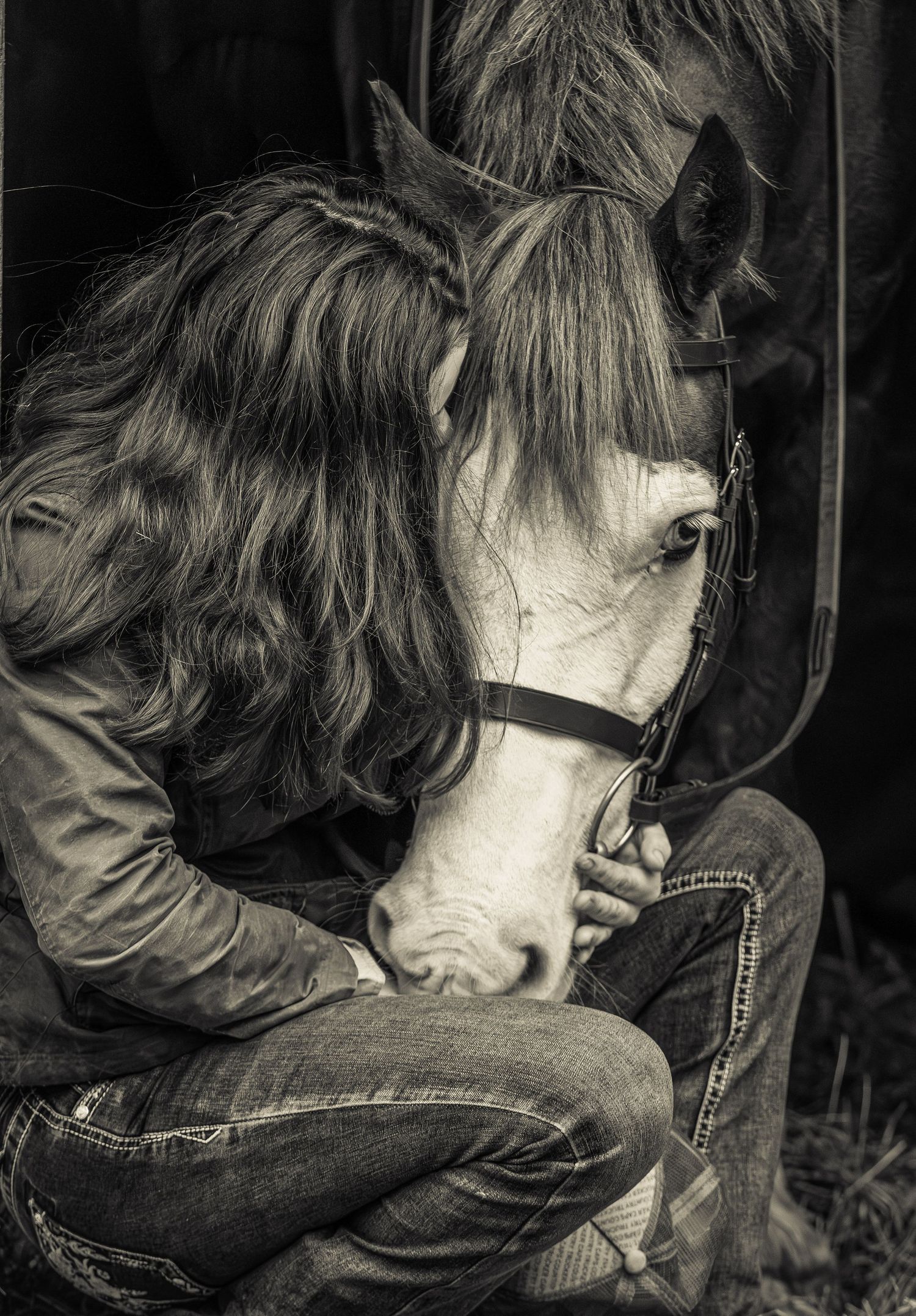 A series of black and white photographs showing a person with a horse in intimate close-up moments.